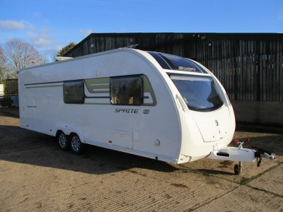 A 2015 model Swift Sprite Quattro FB twin axle caravan in front of the barn