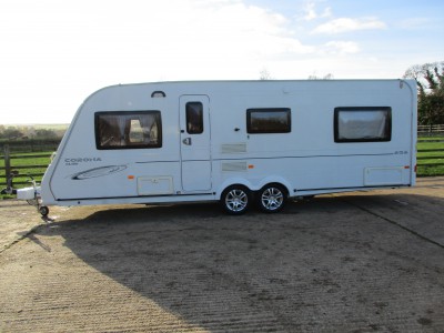 A Compass Corona 626 Club six berth twin axle caravan, with fields behind